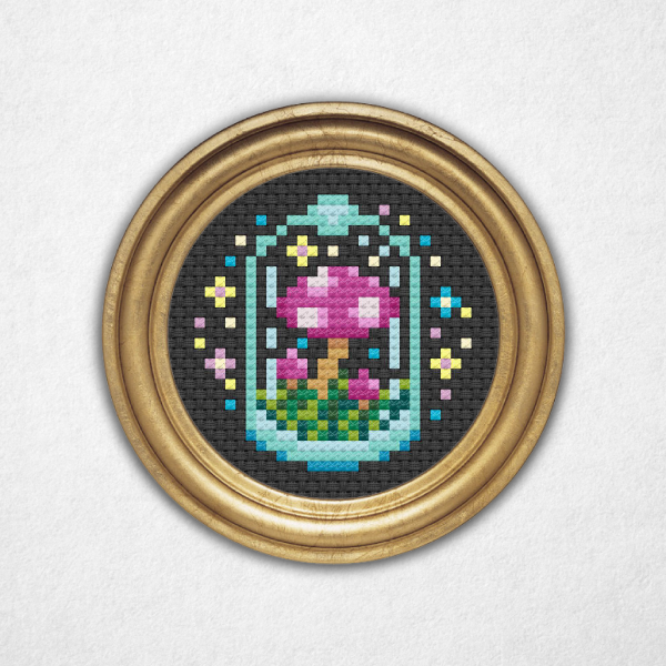 Digital rendering of a mini cross stitch pattern on black aida cloth in a round gold frame of a group of pink and purple mushrooms with white spots in a glass container surrounded by colorful sparkles and stars!