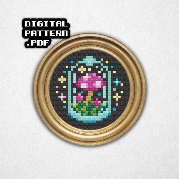 Digital rendering of a mini cross stitch pattern on black aida cloth in a round gold frame of a group of pink and purple mushrooms with white spots in a glass container surrounded by colorful sparkles and stars! Digital Pattern PDF is in bold text in the top left.